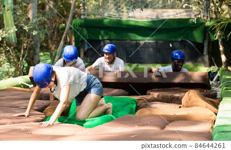 Men and women passing water obstacles Men and women passing water obstacles 84644261