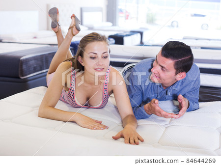 Man and woman choosing mattress Man and woman choosing mattress 84644269