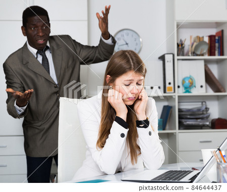Upset woman with angry boss 84644437