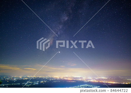 Panorama view universe space shot of milky way galaxy with stars on night sky background at mountains and city light landscape Thailand Panorama view universe space shot of milky way galaxy with stars on night sky background at mountains and city light landscape Thailand 84644722