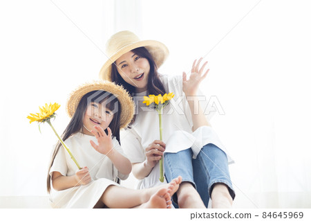 Portrait of a parent and child with a sunflower 84645969