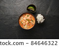 Tom Yam kung Spicy Thai soup with shrimp, seafood, coconut milk and chili pepper in bowl  84646322