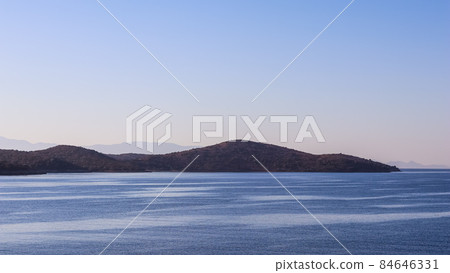 Sea, mountains and blue sky over horizon in the morning. Tranquil seascape and coastal nature background 84646331
