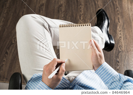 businessman with notepad, works in the office 84646964