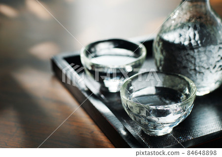 Cold sake in the sunlight through the trees Cold sake in the sunlight through the trees 84648898