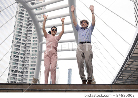 Happy success senior Asian couples are glad and jumping on a trip together. Happy success senior Asian couples are glad and jumping on a trip together. 84650002