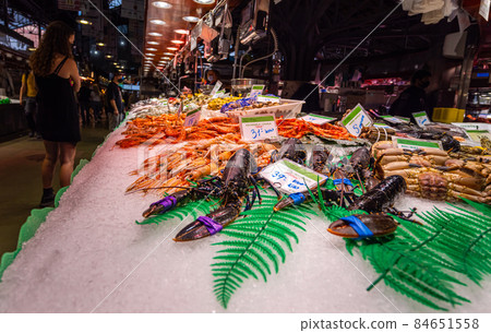Barcelona, Spain - September 23, 2021: Inside the Mercat de la Boqueria or simply La Boqueria, large public market at La Rambla, Barcelona. Fishmonger and seafood stalls with big variety of fresh fish 84651558