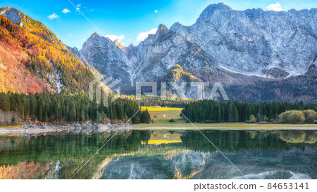 Astonishing view of Fusine lake with Mangart peak on background Astonishing view of Fusine lake with Mangart peak on background 84653141