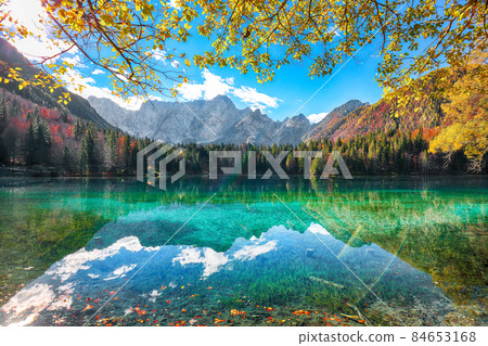 Breathtaking view of Fusine lake with Mangart peak on background Breathtaking view of Fusine lake with Mangart peak on background 84653168