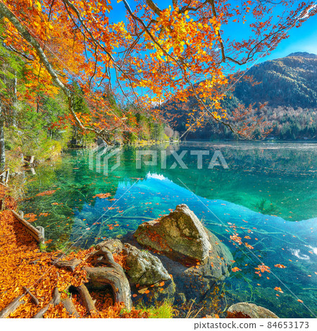 Fairytale view of Fusine lake with Mangart peak on background Fairytale view of Fusine lake with Mangart peak on background 84653173