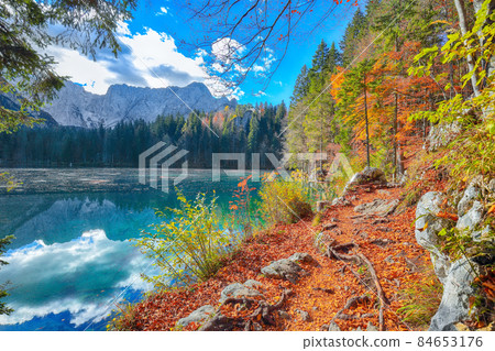 Fairytale view of Fusine lake with Mangart peak on background Fairytale view of Fusine lake with Mangart peak on background 84653176