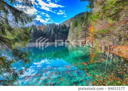 Fairytale view of Fusine lake with Mangart peak on background Fairytale view of Fusine lake with Mangart peak on background 84653177