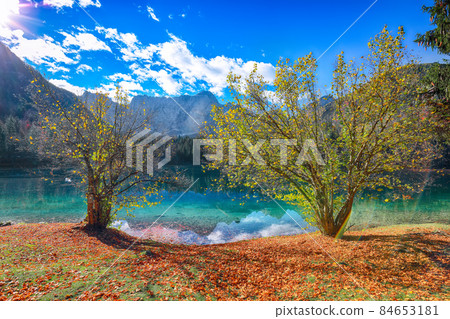 Fairytale view of Fusine lake with Mangart peak on background Fairytale view of Fusine lake with Mangart peak on background 84653181