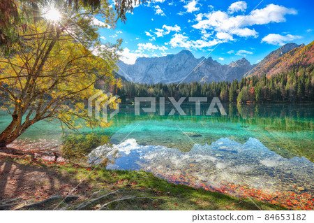 Breathtaking view of Fusine lake with Mangart peak on background Breathtaking view of Fusine lake with Mangart peak on background 84653182