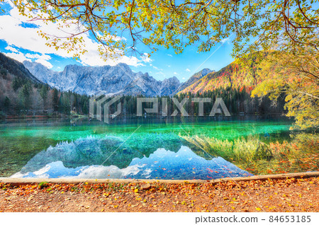 Astonishing view of Fusine lake with Mangart peak on background Astonishing view of Fusine lake with Mangart peak on background 84653185
