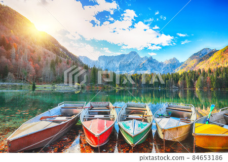 Marvelous view of sunset over Fusine lake with Mangart peak on background Marvelous view of sunset over Fusine lake with Mangart peak on background 84653186