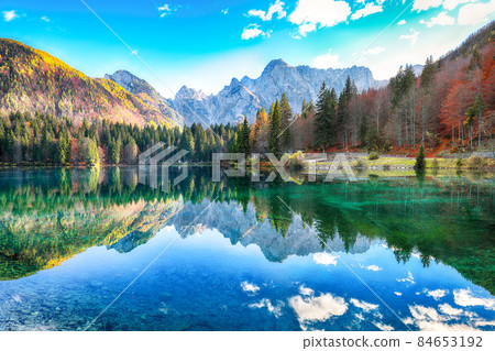 Astonishing view of Fusine lake with Mangart peak on background Astonishing view of Fusine lake with Mangart peak on background 84653192