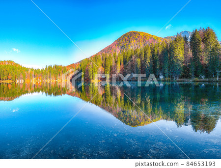 Astonishing view of Fusine lake with Mangart peak on background Astonishing view of Fusine lake with Mangart peak on background 84653193