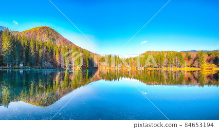 Astonishing view of Fusine lake with Mangart peak on background Astonishing view of Fusine lake with Mangart peak on background 84653194