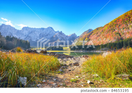 Fairytale view of Fusine lake with Mangart peak on background Fairytale view of Fusine lake with Mangart peak on background 84653195