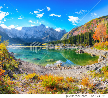 Fairytale view of Fusine lake with Mangart peak on background Fairytale view of Fusine lake with Mangart peak on background 84653196