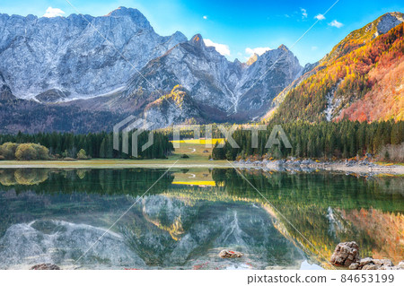 Fairytale view of Fusine lake with Mangart peak on background Fairytale view of Fusine lake with Mangart peak on background 84653199