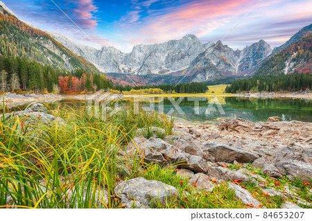 Astonishing view of Fusine lake with Mangart peak on background. Astonishing view of Fusine lake with Mangart peak on background. 84653207