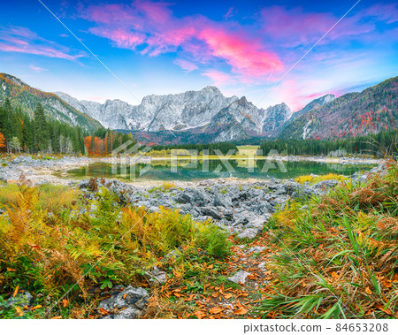 Stunning view of Fusine lake with Mangart peak on background. Stunning view of Fusine lake with Mangart peak on background. 84653208