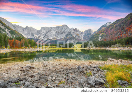 Stunning view of Fusine lake with Mangart peak on background. 84653215