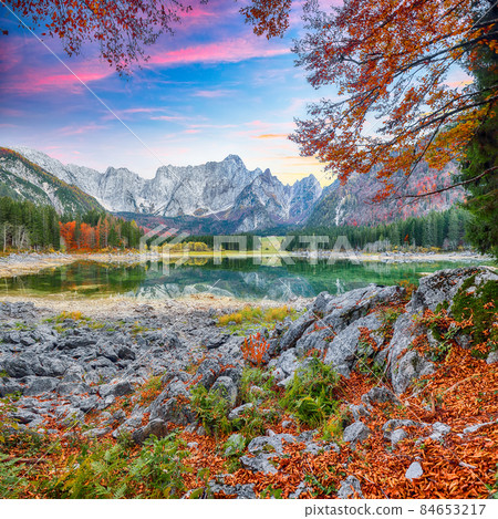 Stunning view of Fusine lake with Mangart peak on background. Stunning view of Fusine lake with Mangart peak on background. 84653217