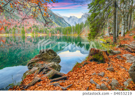 Fairytale view of Fusine lake with Mangart peak on background. Fairytale view of Fusine lake with Mangart peak on background. 84653219