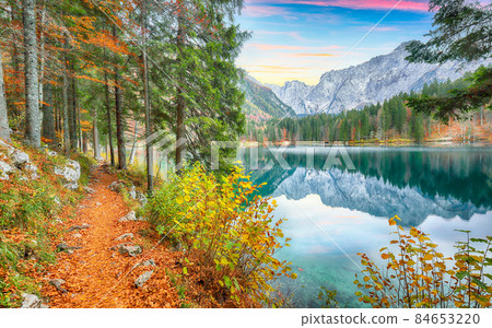Fairytale view of Fusine lake with Mangart peak on background. Fairytale view of Fusine lake with Mangart peak on background. 84653220