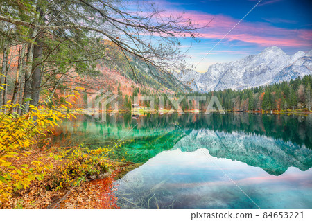 Fairytale view of Fusine lake with Mangart peak on background. Fairytale view of Fusine lake with Mangart peak on background. 84653221