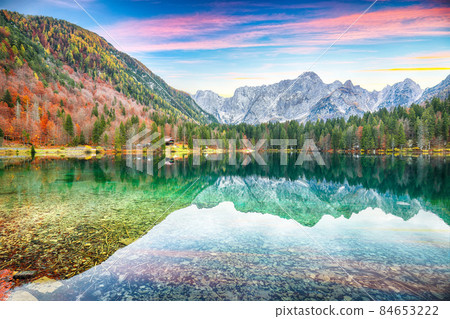 Fairytale view of Fusine lake with Mangart peak on background. 84653222