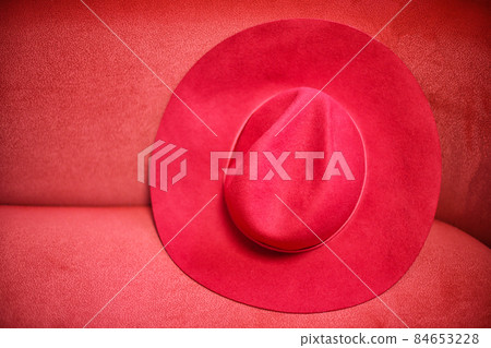 Elegance lady red hat on the red background. Elegance lady red hat on the red background. 84653228