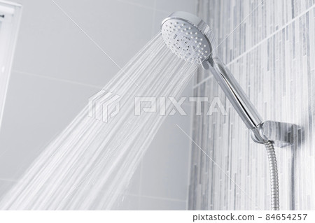 Chrome shower head with splashing water. Modern shower head.  84654257