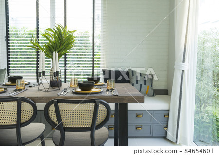 dining table with black and yellow plate setting in modern home. 84654601