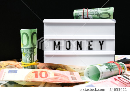 Lightbox board with the word MONEY in black letters around Euro banknotes. Finance background. Business, financial success and making money concept. Business budget of wealth and prosperity finance Lightbox board with the word MONEY in black letters around Euro banknotes. Finance background. Business, financial success and making money concept. Business budget of wealth and prosperity finance 84655421