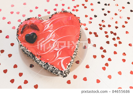 Valentines Day heart shaped cake with chocolate and strawberries on plate, white with red hearts confetti background. Festive dessert for date, anniversaries and party concept. Close up, copy space Valentines Day heart shaped cake with chocolate and strawberries on plate, white with red hearts confetti background. Festive dessert for date, anniversaries and party concept. Close up, copy space 84655686