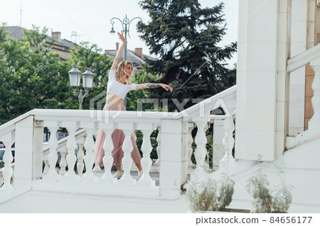beautiful blonde woman dancing to music outside beautiful blonde woman dancing to music outside 84656177