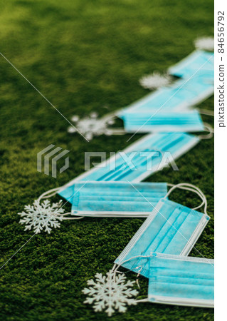 Christmas Tree Made of Medical Masks on a Green Background With Copy Space 84656792