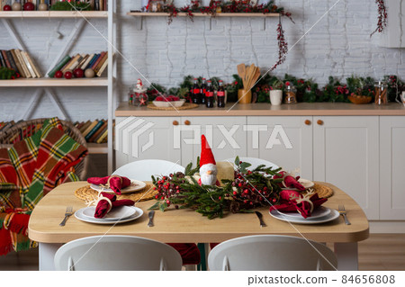 Beautiful table setting with Christmas decor in living room. Beautiful table setting with Christmas decor in living room. 84656808