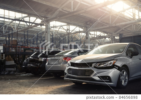 Many unknown altered wrecked car after traffic accident crash at restore service maintenance station garage indoor. Insurance salvage vehicle auction wholesale. Auto body wreck damage workshop center Many unknown altered wrecked car after traffic accident crash at restore service maintenance station garage indoor. Insurance salvage vehicle auction wholesale. Auto body wreck damage workshop center 84656898