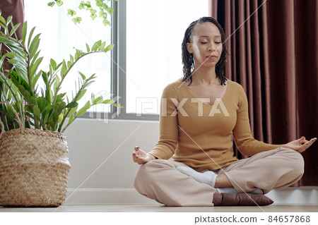 Woman Meditating to Stay Calm 84657868