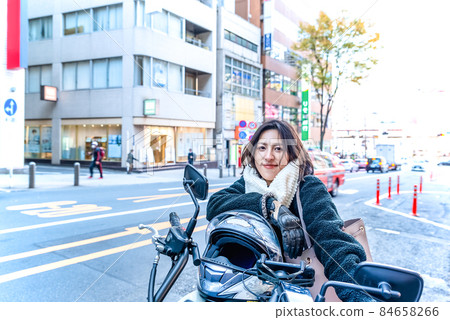Business woman commuting by motorcycle Shibuya Business woman commuting by motorcycle Shibuya 84658266