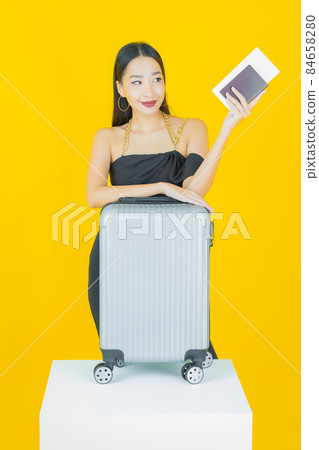Portrait beautiful young asian woman with luggage bag and passport Portrait beautiful young asian woman with luggage bag and passport 84658280