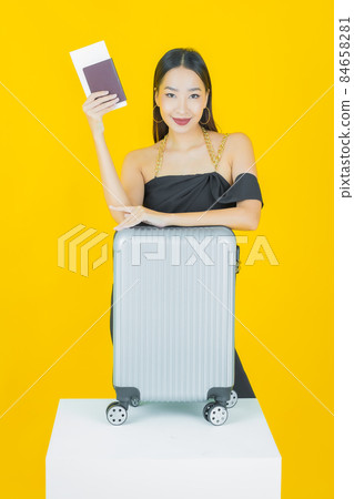 Portrait beautiful young asian woman with luggage bag and passport Portrait beautiful young asian woman with luggage bag and passport 84658281
