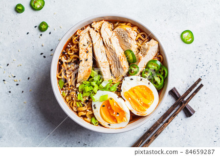Asian noodle soup ramen with chicken and egg in gray bowl. Japanese food concept. 84659287