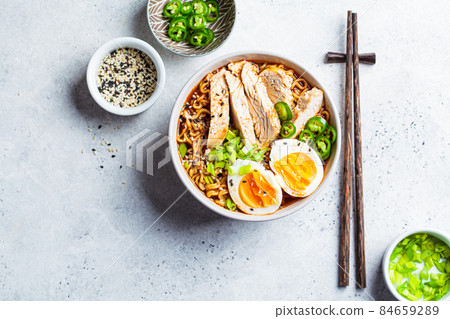 Asian noodle soup ramen with chicken and egg in gray bowl. Japanese food concept. Asian noodle soup ramen with chicken and egg in gray bowl. Japanese food concept. 84659289