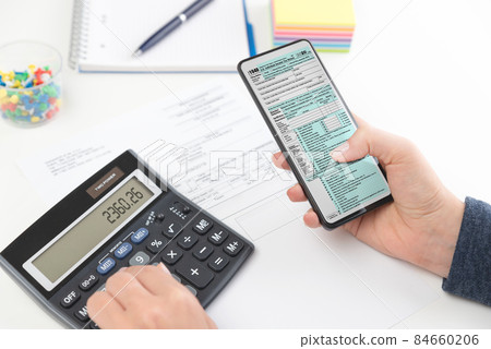 Accountant working with US tax forms Accountant working with US tax forms 84660206